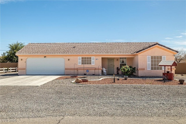 ranch-style home with stucco siding, fence, a tile roof, an attached garage, and driveway