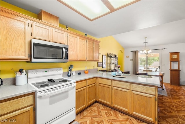 kitchen featuring light countertops, stainless steel microwave, white range with electric stovetop, and a peninsula
