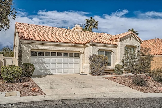 9532 Calico Garden Ave, Las Vegas, NV 89134 - mediterranean / spanish-style home with concrete driveway, a tiled roof, a garage, and stucco siding