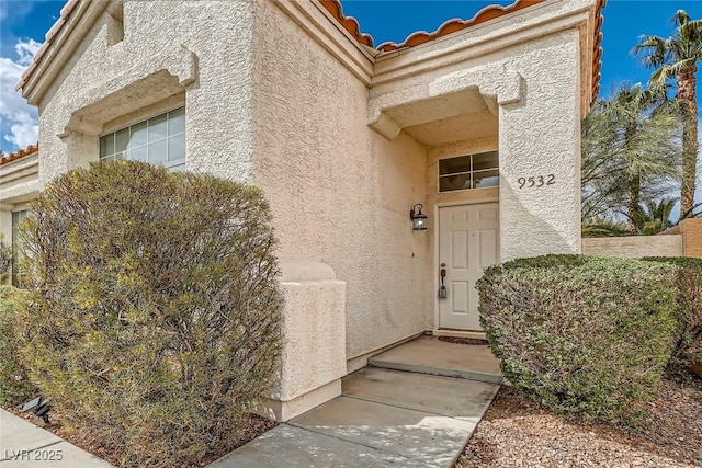 9532 Calico Garden Ave, Las Vegas, NV 89134 - entrance to property with stucco siding and a tile roof