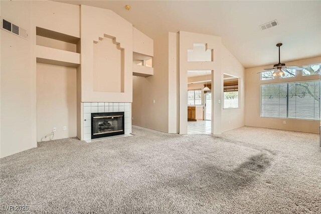 9532 Calico Garden Ave, Las Vegas, NV 89134 - unfurnished living room with ceiling fan, a fireplace, light colored carpet, and high vaulted ceiling