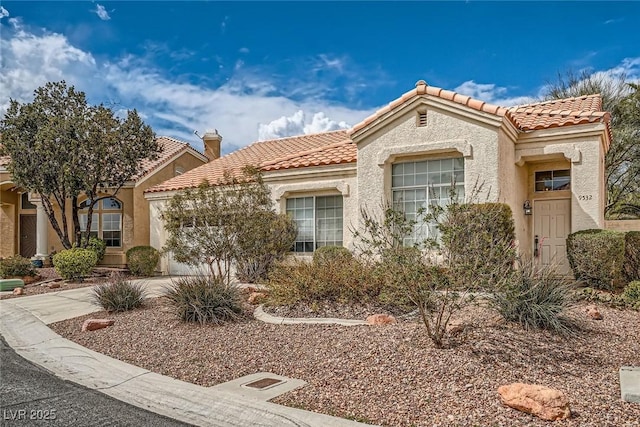 9532 Calico Garden Ave, Las Vegas, NV 89134 - mediterranean / spanish-style house with an attached garage, a tile roof, and stucco siding