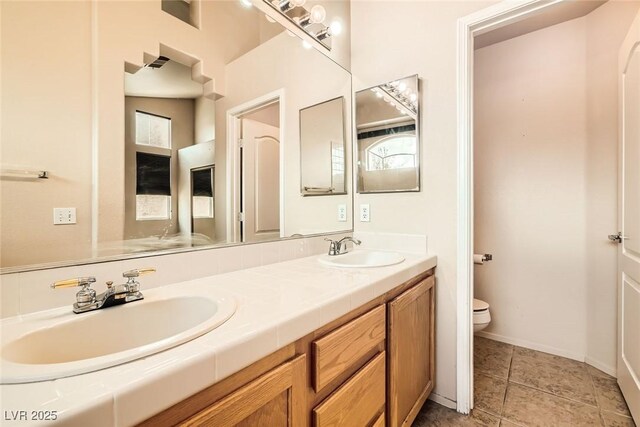 9532 Calico Garden Ave, Las Vegas, NV 89134 - full bath with toilet, double vanity, and baseboards