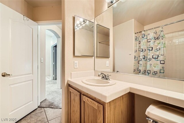 9532 Calico Garden Ave, Las Vegas, NV 89134 - full bath featuring vanity, tile patterned floors, toilet, and a shower with curtain