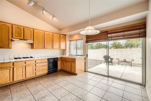 9532 Calico Garden Ave, Las Vegas, NV 89134 - kitchen featuring under cabinet range hood, rail lighting, tile countertops, light tile patterned floors, and lofted ceiling