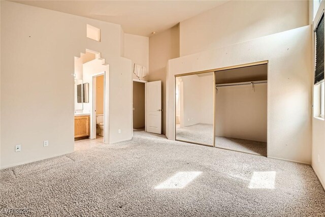 9532 Calico Garden Ave, Las Vegas, NV 89134 - unfurnished bedroom featuring high vaulted ceiling, carpet, a closet, and ensuite bathroom
