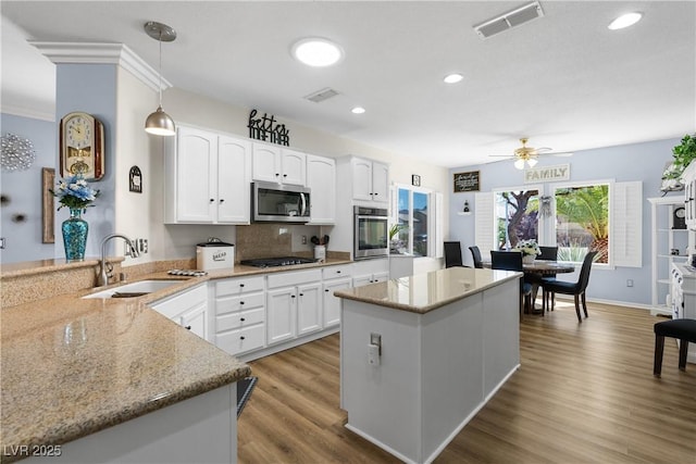 2606 Crested Butte St, Henderson, NV 89052 - kitchen featuring visible vents, light stone countertops, ceiling fan, a sink, and stainless steel appliances