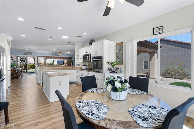 2606 Crested Butte St, Henderson, NV 89052 - dining space with a ceiling fan, visible vents, light wood-style flooring, and recessed lighting