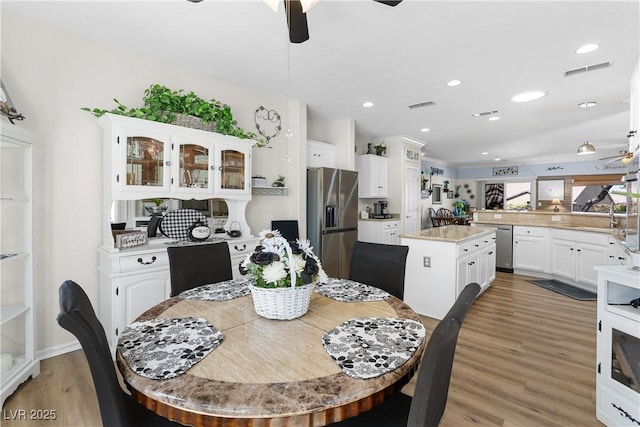 2606 Crested Butte St, Henderson, NV 89052 - dining space featuring visible vents, a ceiling fan, light wood-style flooring, and recessed lighting