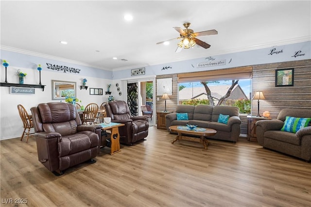 2606 Crested Butte St, Henderson, NV 89052 - living room with a healthy amount of sunlight, ornamental molding, a ceiling fan, and light wood-style flooring