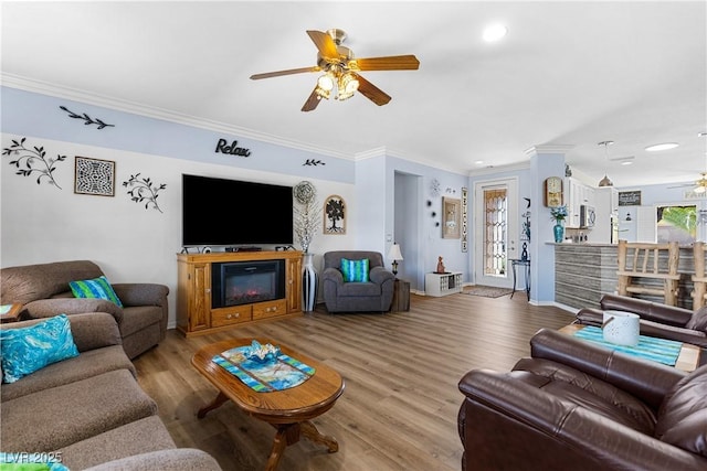 2606 Crested Butte St, Henderson, NV 89052 - living room with crown molding, wood finished floors, baseboards, ceiling fan, and recessed lighting