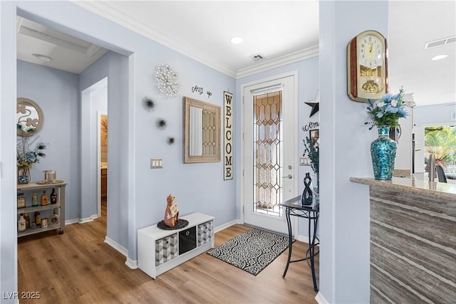 2606 Crested Butte St, Henderson, NV 89052 - entryway featuring visible vents, ornamental molding, baseboards, and wood finished floors