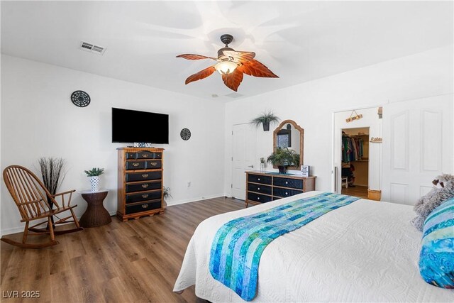 2606 Crested Butte St, Henderson, NV 89052 - bedroom featuring visible vents, wood finished floors, baseboards, ceiling fan, and a spacious closet