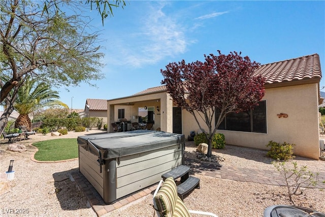 2606 Crested Butte St, Henderson, NV 89052 - back of property featuring a patio, stucco siding, a hot tub, and a tile roof