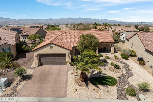 2606 Crested Butte St, Henderson, NV 89052 - view of front of home with a residential view, a tile roof, a garage, stucco siding, and decorative driveway
