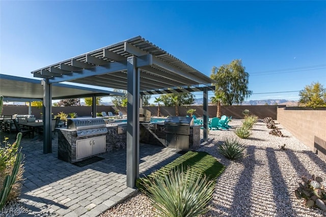 8637 Home Gate Ct, Las Vegas, NV 89113 - view of patio featuring an outdoor kitchen, a fenced backyard, and a pergola