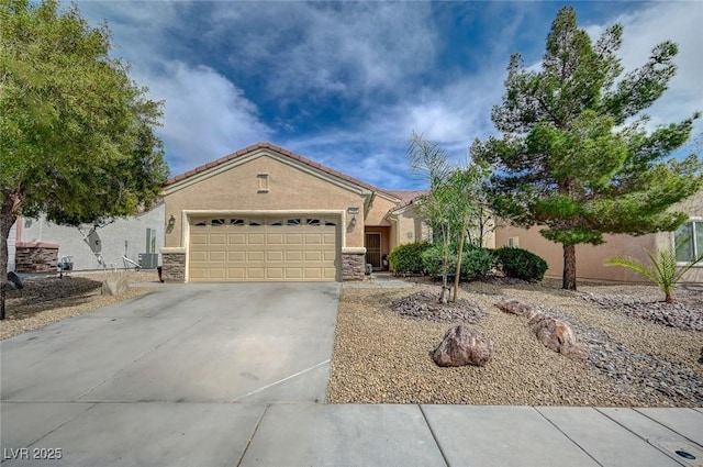 7460 Chaffinch St, North Las Vegas, NV 89084 - single story home featuring concrete driveway, stucco siding, a garage, and stone siding