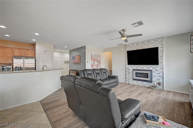 7460 Chaffinch St, North Las Vegas, NV 89084 - living area with ceiling fan, recessed lighting, a fireplace, and wood finished floors