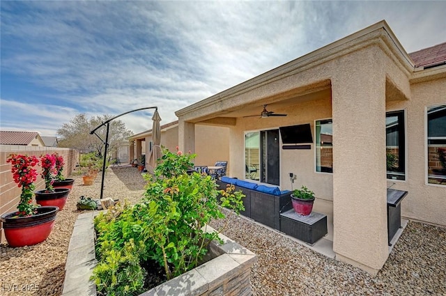 7460 Chaffinch St, North Las Vegas, NV 89084 - rear view of property with stucco siding, ceiling fan, a fenced backyard, a vegetable garden, and a patio