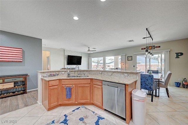 7460 Chaffinch St, North Las Vegas, NV 89084 - kitchen with stainless steel dishwasher, a sink, a ceiling fan, light tile patterned floors, and open floor plan