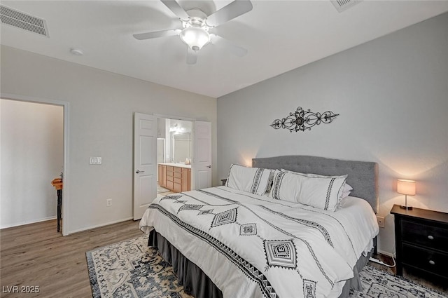 7460 Chaffinch St, North Las Vegas, NV 89084 - bedroom with wood finished floors, baseboards, a ceiling fan, and ensuite bathroom