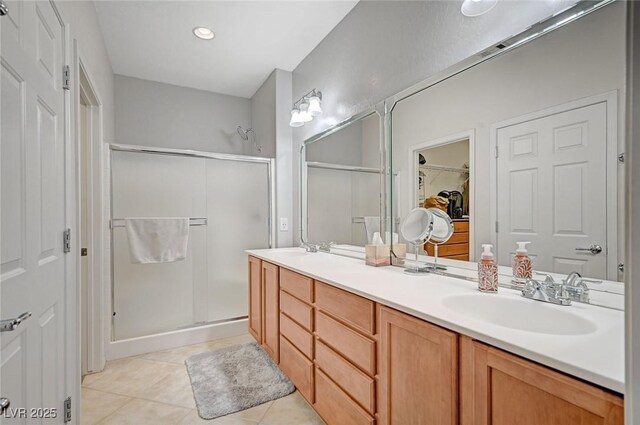 7460 Chaffinch St, North Las Vegas, NV 89084 - bathroom with a stall shower, double vanity, tile patterned flooring, and a walk in closet