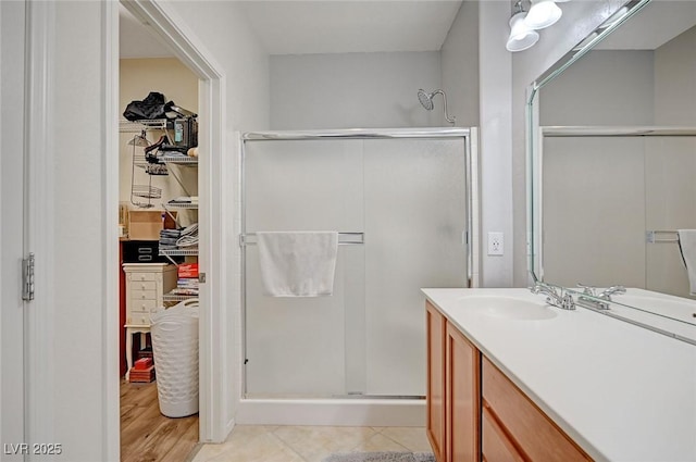 7460 Chaffinch St, North Las Vegas, NV 89084 - full bathroom featuring a shower stall, a spacious closet, vanity, and wood finished floors