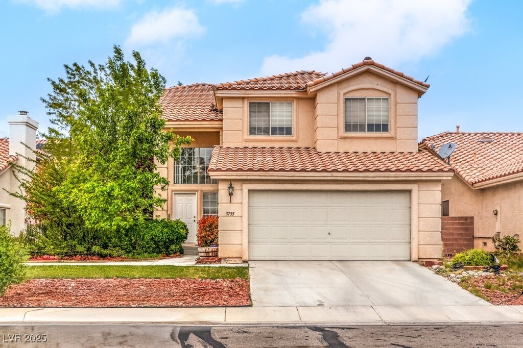 mediterranean / spanish house featuring a tile roof, driveway, a garage, and stucco siding