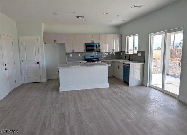kitchen featuring decorative backsplash, visible vents, dishwasher, electric stove, and black microwave