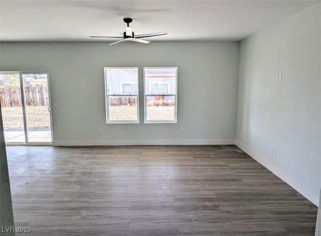 spare room with a ceiling fan, baseboards, and wood finished floors
