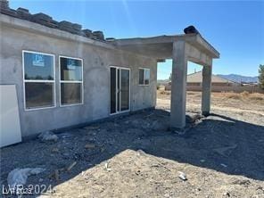 back of house with stucco siding