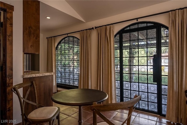 dining space with recessed lighting and vaulted ceiling