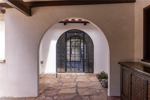 detailed view of stucco siding and arched walkways