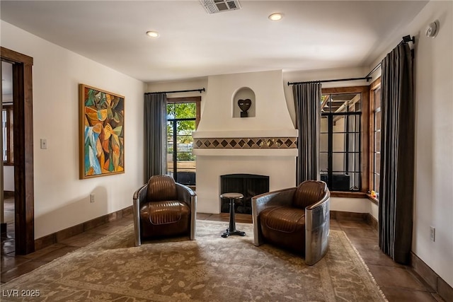sitting room featuring baseboards, a fireplace, tile patterned floors, and recessed lighting