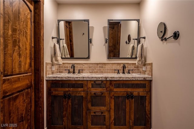 bathroom featuring backsplash and double vanity