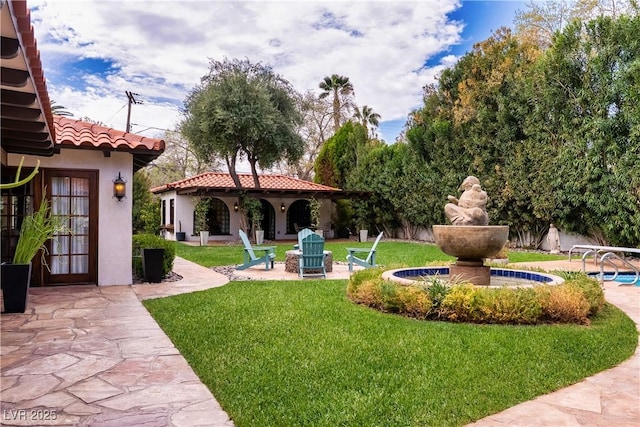 view of green lawn with a patio area