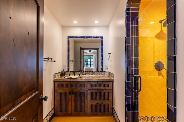 full bath featuring a stall shower, vanity, baseboards, recessed lighting, and tile patterned floors