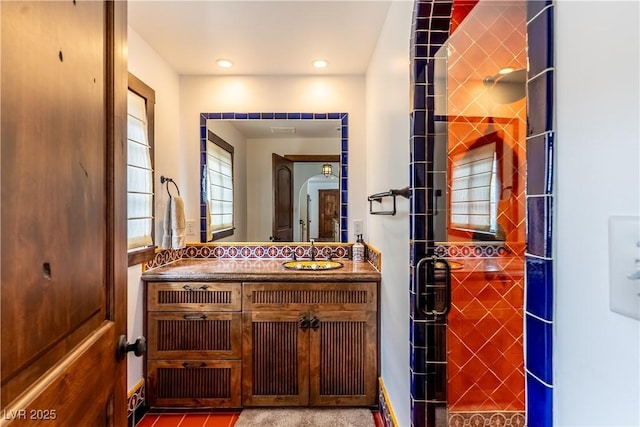 full bath featuring vanity and a shower with shower door