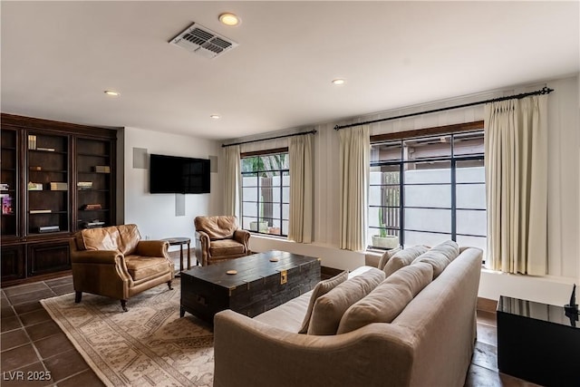 living room with recessed lighting and dark tile patterned floors