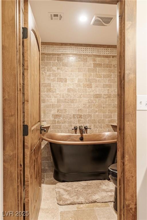 bathroom featuring a soaking tub