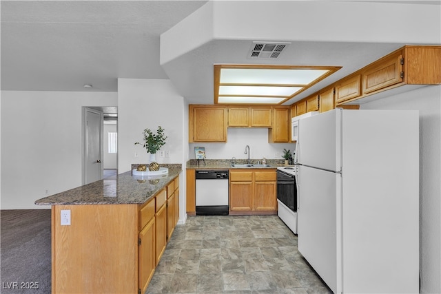 8410 Eldora Ave Unit 2045, Las Vegas, NV 89117 - kitchen with white appliances, a peninsula, dark stone counters, and stone finish flooring