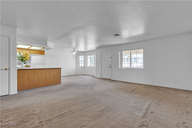 8410 Eldora Ave Unit 2045, Las Vegas, NV 89117 - unfurnished living room featuring ceiling fan, light carpet, and a textured ceiling