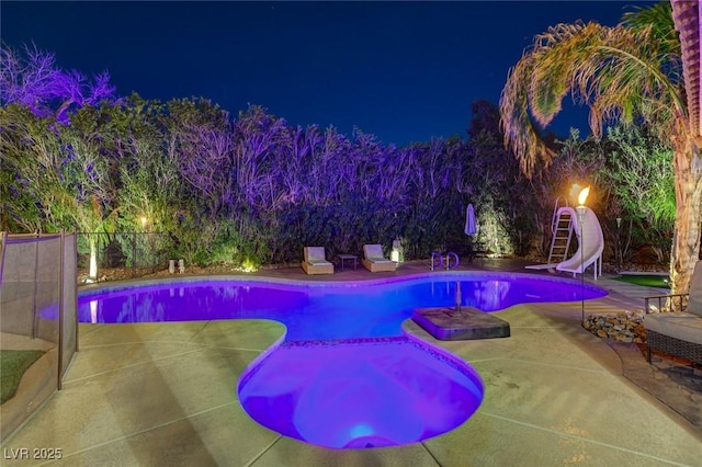 pool at twilight featuring a fenced in pool, a patio, a water slide, and fence