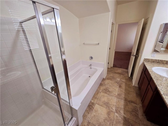 bathroom with a bath, vanity, stone tile floors, and a stall shower