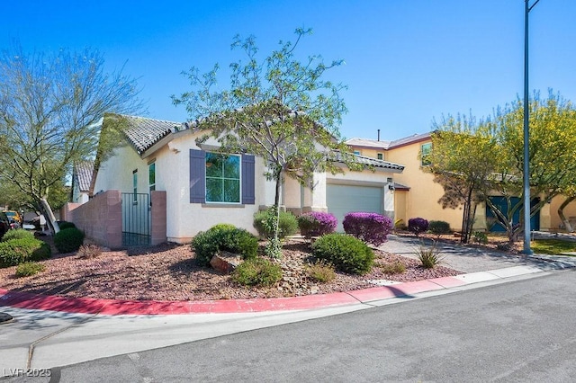 4032 Little Bay Ave, North Las Vegas, NV 89081 - view of front of house with stucco siding, an attached garage, driveway, and a gate