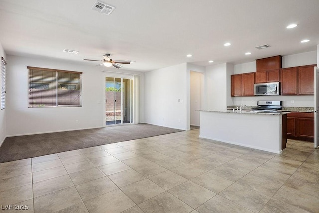 4032 Little Bay Ave, North Las Vegas, NV 89081 - kitchen with stainless steel appliances, recessed lighting, ceiling fan, light colored carpet, and baseboards