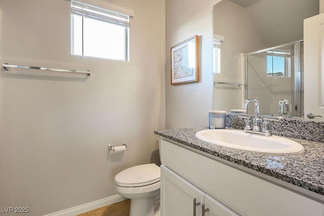 9871 Magnus Ct, Las Vegas, NV 89178 - bathroom featuring vanity, a shower stall, toilet, and baseboards