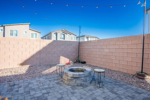 9871 Magnus Ct, Las Vegas, NV 89178 - fenced backyard featuring a patio and an outdoor fire pit