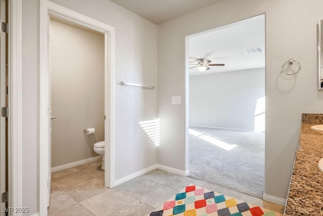9871 Magnus Ct, Las Vegas, NV 89178 - bathroom with toilet, vanity, a ceiling fan, and baseboards