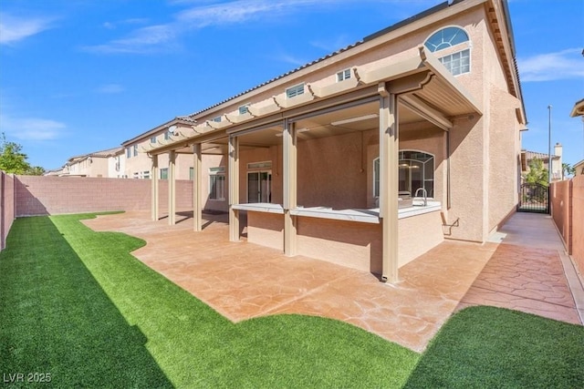 6335 Mount Eden Ave, Las Vegas, NV 89139 - rear view of house featuring a patio area, a gate, and stucco siding